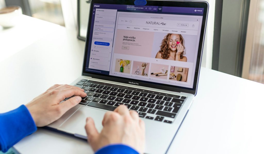 a person using a laptop computer on a table